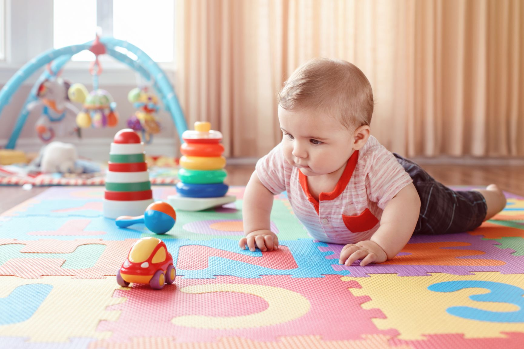 boy looking at car toy